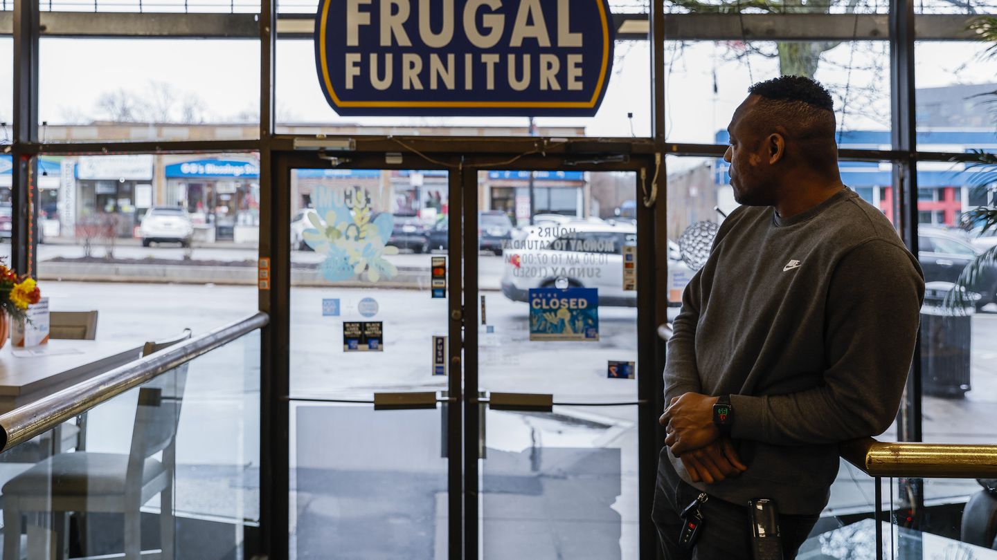 Yvens Jean Batiste, manager of Frugal Furniture, looked out onto Blue Hill Avenue, where his store is located.