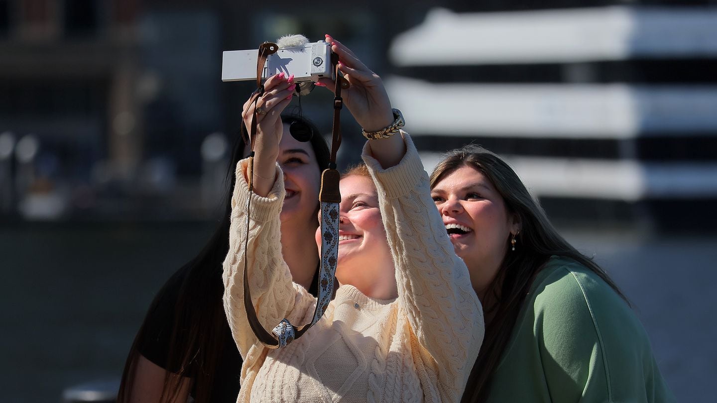Friends from Texas take a selfie on the waterfront on a warm, sunny day in the Seaport District Thursday when spring seemed to arrive before the calendar says it should. Left to right, Jessica Frannea, Danica Reynolds, and Lois Hill were all smiles.