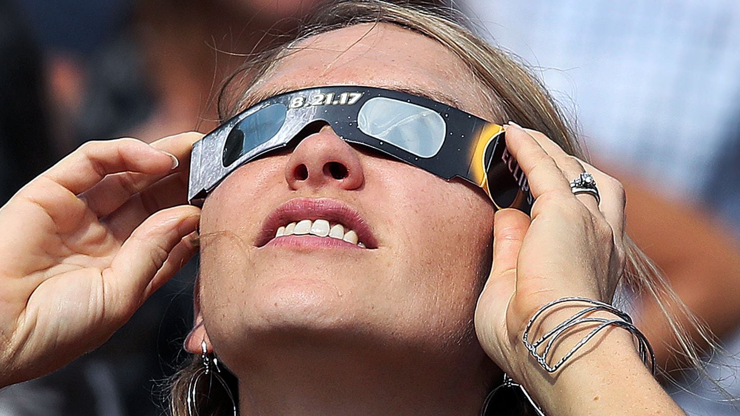 An eclipse watcher in 2017 wears mylar filters as she attends an event at the Kresge Oval on the campus of MIT.